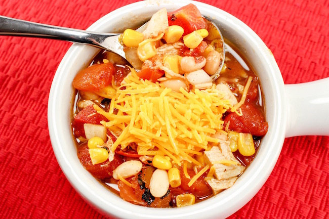 The Crockpot Chicken Chili recipe great to pop in the slow cooker in the morning before you leave for work or even the night before and start it up.