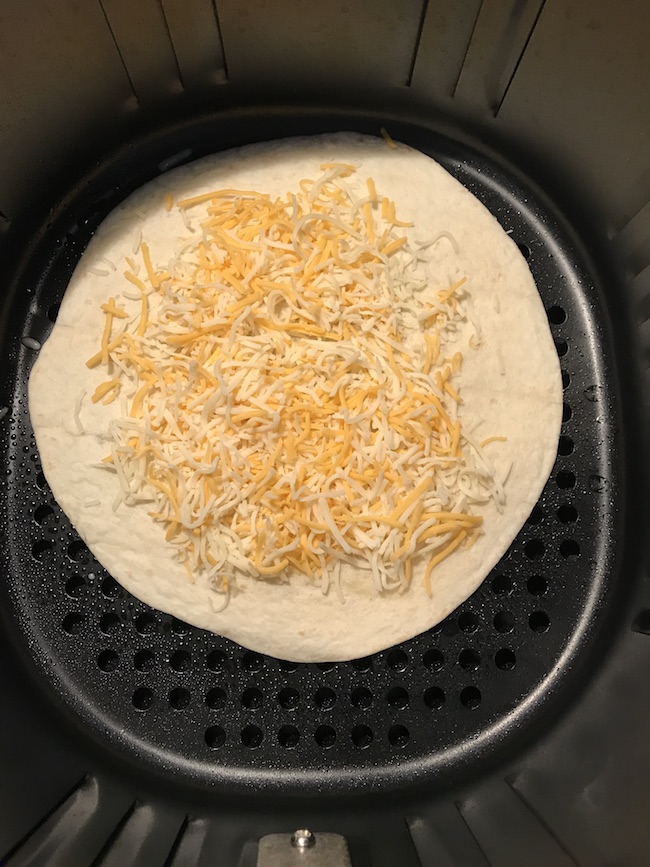 Adding cheese on the quesadilla