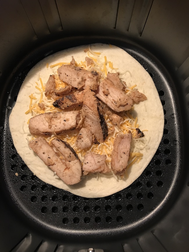 Adding chicken to top of cheese on quesadilla