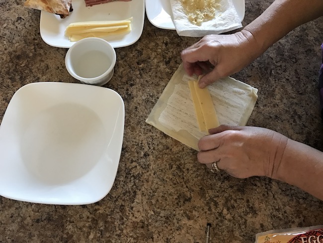 Air Fryer Reuben Egg Rolls recipe for St. Patrick's Day is filled with Corned Beef, Melted Swiss Cheese, Sauerkraut and dipped in 1000 Island dressing.