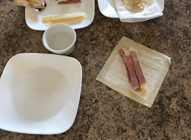 Air Fryer Reuben Egg Rolls recipe for St. Patrick's Day is filled with Corned Beef, Melted Swiss Cheese, Sauerkraut and dipped in 1000 Island dressing.