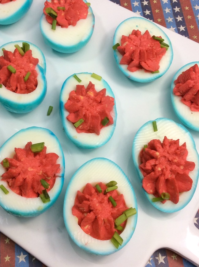 Who doesn't love deviled eggs? This year we are making them for our Memorial Day party with a twist, red, white, & blue Patriotic Deviled Eggs recipe.