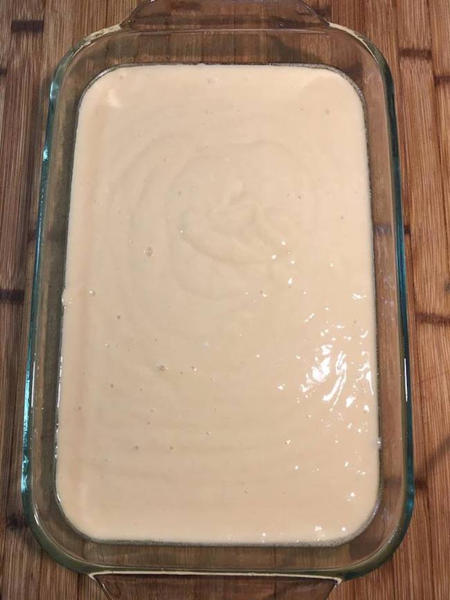 Cake mix in glass pan for poke cake recipe