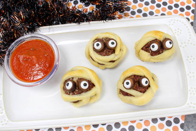 Who doesn't love a halloween Mummy Meatball recipe? The kids will go crazy over these and you won't because they are super easy to make.