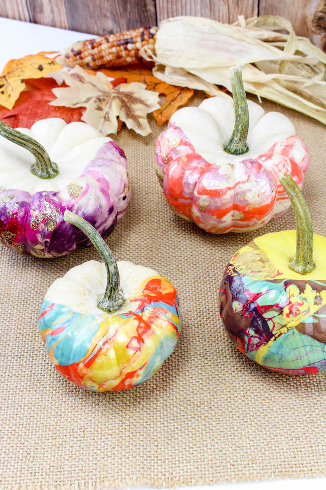 Nail polish colored pumpkins with metallic accents.
