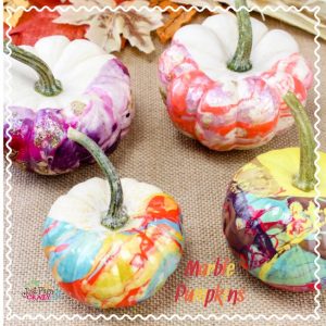 Nail polish pumpkins with varying marble designs.