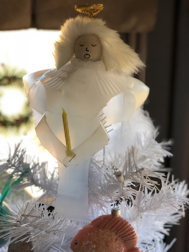 I can use the Milk Jug Angel on my table as a decoration on top of a flameless candle and the light shines through or as a tree top decoration.