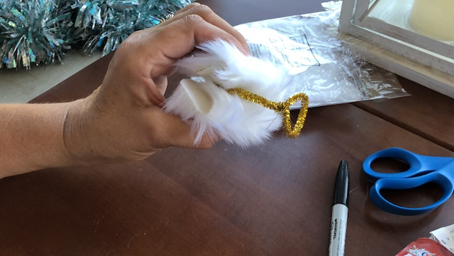 I can use the Milk Jug Angel on my table as a decoration on top of a flameless candle and the light shines through or as a tree top decoration.