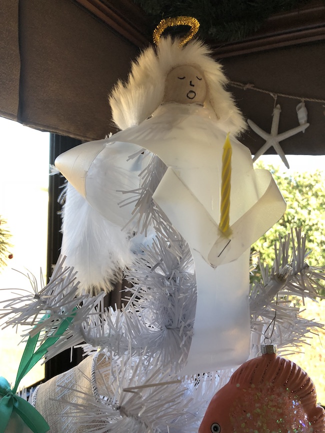 I can use the Milk Jug Angel on my table as a decoration on top of a flameless candle and the light shines through or as a tree top decoration.