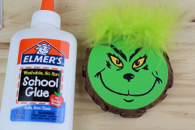 Adding a feather to the top of the Grinch ornament