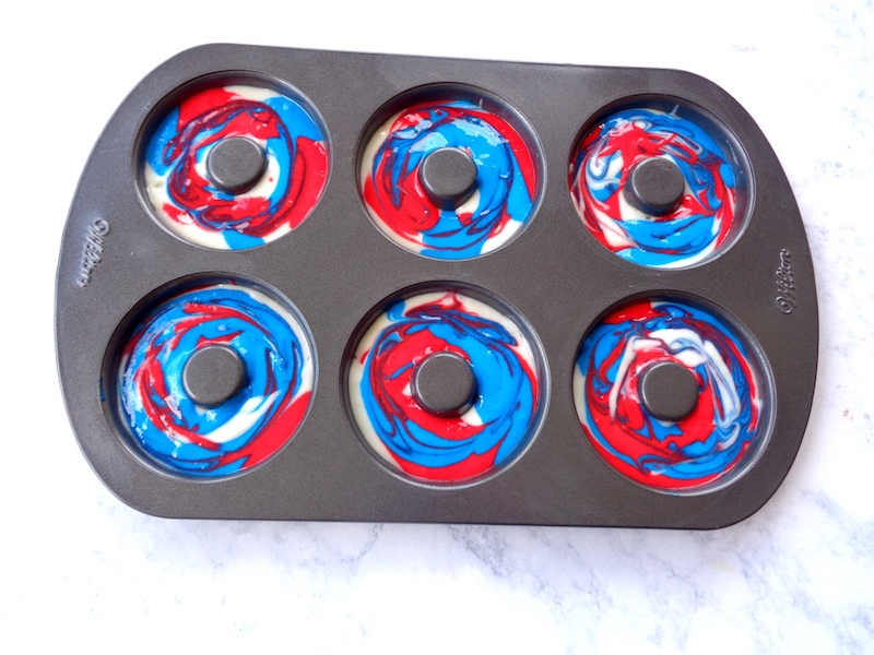 Adding batter to donut pan.